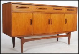A 1970's G-Plan kelso teak wood sideboard of Danish influence having short drawers and cupboards
