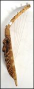 A vintage 20th century African tribal 5 string harp of wooden and animal hide construction with