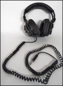A pair of retro boxed Sony Hi - Fi headphones fitted with volume controls to the earpiece.