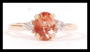 A 14ct yellow gold, tourmaline and diamond ladies 3 stone ring. The stunning central stone with