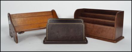 A mid 20th century metamorphic book trough together with a two leather covered desk tidies