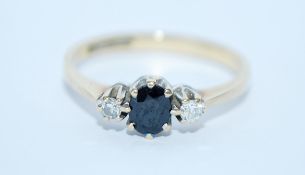 A hallmarked 9ct gold, diamond and sapphire three stone ring. Size M. Weight 1.7g.