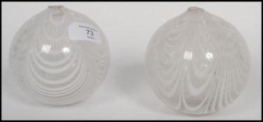 A pair of early 19th century Nailsea glass witch balls having a banded white design.