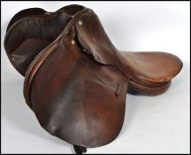 A vintage 20th century English made horse riding saddle, stamped to both sides of the saddle made in