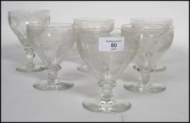 A group of six 18th century Georgian glass rummers, five matching raised on a plain foot with