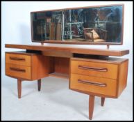 A 1970's G-Plan teak wood dressing table in the manner of Mogens Kolo. The dressing table raised