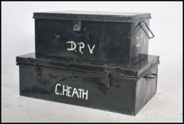 Two vintage 20th century retro industrial ebonised steamer trunks having bold white lettering to lid