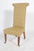 A 19th century Victorian prayer chair raised on castors with turned wood legs to the front and