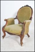 A Victorian 19th century walnut spoon back armchair raised on lavishly carved cabriole legs and