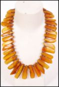 A fantastic amber and silver necklace having varying baroque amber pieces separated by silver ball