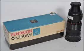 A vintage Pentacon Objektive 4/300 VB M42 X 1 Camera Telephoto Lens complete in the original box.