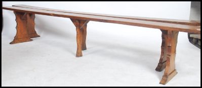 An exceptional pair of 19th century French fruitwood polished refectory pig benches. Each with