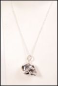A contemporary silver scull necklace pendant compl