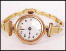 A 9ct gold / 375 marked vintage ladies wristwatch set to a later yellow metal bracelet. The watch