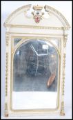 A large over-mantel 19th century painted mirror having a swan neck pediment with a central painted