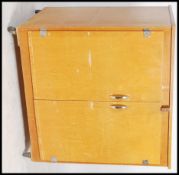 A mid century / 1970's retro beech wood school cupboard having formica top over cupboards with inset