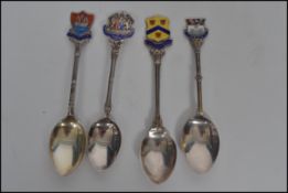 A group of four silver hallmarked and enamel spoons with armorial coat of arms to top for Padstow,