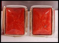 A pair of silver and apple coral clip on earrings complete in the presentation case.