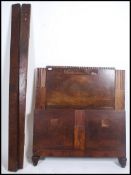 A 1930's Art Deco walnut single bed having tall panel headboard with embellished details complete