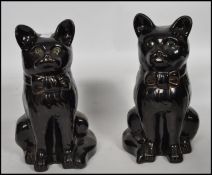 A pair of 19th century Victorian ceramic Jackfield Staffordshire earthenware cat figurines having