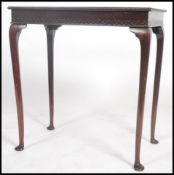 An early 20th century mahogany side / lamp table raised on cabriole legs with pad feet having a