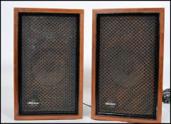 A pair of vintage retro 20th century teak cased Sony SS210 speakers with mesh front covers and brass