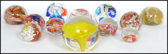 A good collection of 12 vintage studio glass paperweights to include milliefiori, bubble control