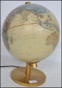 A retro illuminated terrestrial globe raised on a gilt pedestal base, the globe bearing makers