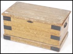 A Victorian pine scrumble finished blanket box chest of small form with hinged lid and plinth