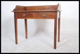 A Victorian mahogany writing table desk being raised on squared legs with twin drawers to the
