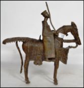 A believed 19th century large brass African tribal sculpted figurine of a warrior on horse back