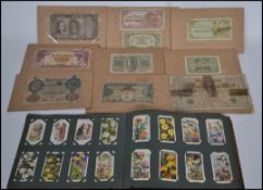 A collection of early 20th century cigarette cards held within an album along with a collection of