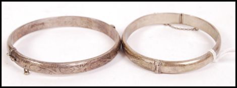 A pair of silver hallmarked clasp bracelet / bangles, both with Birmingham assay marks and dating to