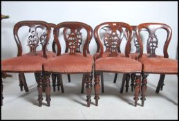A set of 8 Regency / early Victorian mahogany balloon back dining chairs being raised on turned legs