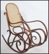 A vintage 20th century Thonet style bentwood rocker / rocking chair with rattan weave seat and