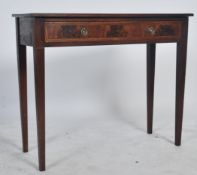 An Edwardian mahogany inlaid writing table desk being crossbanded to the borders. Raised on