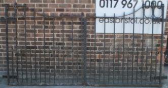 A large pair of 20th century cast and wrought metal ironwork gates of scroll work form having