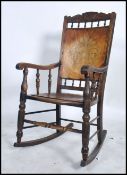 A 19th century panel seat rocking chair raised on bow sleigh runners with gallery frame to the top.