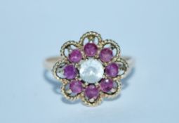 A hallmarked 9ct gold pink and white stone cluster ring. Hallmarked London. Size S. Weight 3.4g.