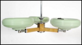 A vintage retro 20th century three branch ceiling with green glass shade along with a black and
