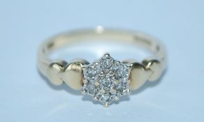 A hallmarked 9ct gold and diamond cluster ring. Hallmarked London. Size M. Weight 2g.