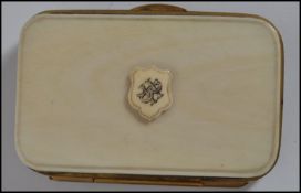 A vintage 19th century ivory and gilt metal purse with monogrammed armorial crest to front push