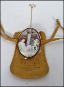 A 19th century ? continental  carved shell cameo brooch depicting a recumbent nude lady with nymph