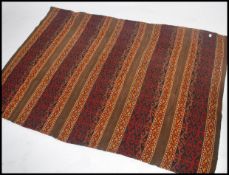 A late 19th century Uzbeki Suzani floor carpet rug textile decorated with bands of geometric
