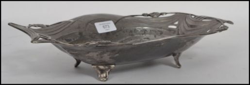 A vintage Art Nouveau pewter dish having pieced rose handles with scalloped edge in the manner of