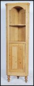 A Victorian / early 20th century pine corner cupboard having a single door cabinet under open