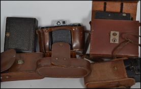 A collection of vintage cameras to include Century bellows camera being mahogany and black canvas