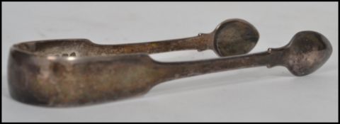 A Georgian silver hallmarked pair of sugar tongs of larger form hallmarked for Sheffield believed