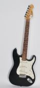 A 20th century six string two tone Fender style electric guitar by Encore having a black and white