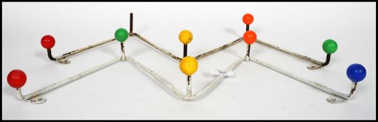 A pair of retro 1960's / mid century hanging tubular metal and multi colour finial coat racks of
